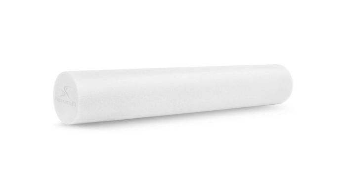 A 6-inch by 3-foot medium density foam roller in a professional gym setting. This essential recovery tool is used alongside The Glute Activator to help roll out muscle tightness and improve mobility.