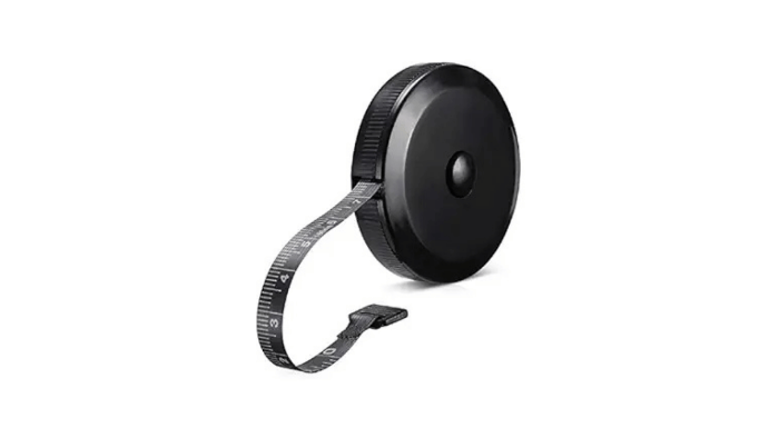 A black retractable body tape measure with a flexible fiberglass tape and a finger loop for easy handling. This tool is used in the Lower Back Reset Method to accurately measure physical dimensions and track alignment progress.